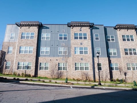 a brick apartment building with a blue sky in the background